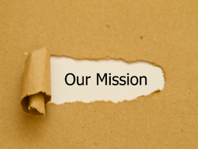 piece of paper ripped to reveal the words "our mission"