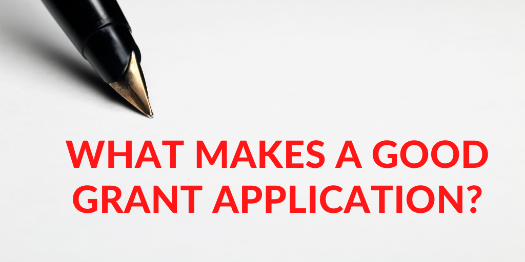 a pen with the text what makes a good grant application