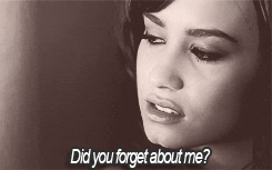 A GIF of Demi Lovato singing to the camera. Underneath their face are the lyrics, "Did you forget about me?"